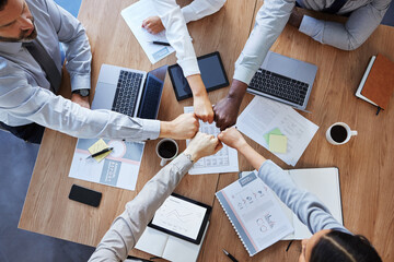 Fist bump, team building or top view of business people in collaboration for group mission in...
