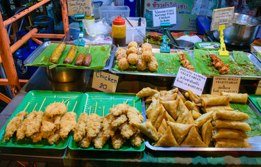 Satays and samosas from traditional food market and bazar in Thailand