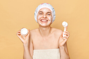 Attractive smiling happy pretty woman wearing shower cap taking bath doing beauty procedures...
