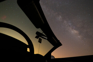 starry night sky with car convertible in the front
