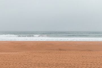 Wandering along the Fisherman Trail in the Algarve region of southwestern Portugal. Human footprints in the sandy surface
