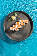 japanese cuisine sushi rolls on blue water background