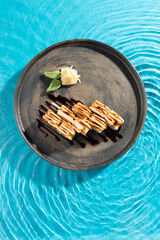 japanese cuisine sushi rolls on blue water background