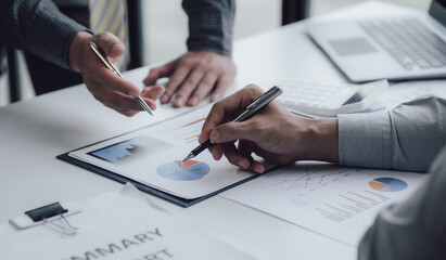 Business people talking about business strategy Collaborate teamwork during discussions on financial and marketing documents, financial data analysis meetings, and in-office charts.