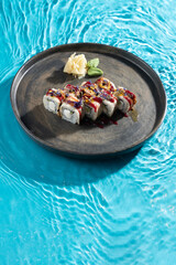 japanese cuisine sushi rolls on blue water background