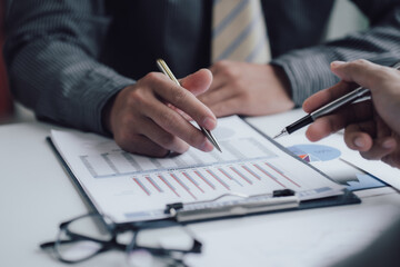 Business people talking about business strategy Collaborate teamwork during discussions on financial and marketing documents, financial data analysis meetings, and in-office charts.