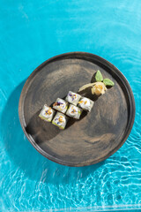japanese cuisine sushi rolls on blue water background