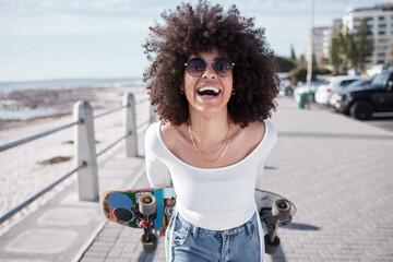 Woman, happy and outdoor with a skateboard for travel, adventure and freedom on a beach road. Face...