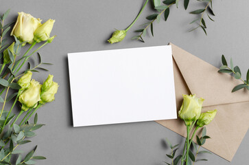 Wedding invitation or greeting card mockup with envelope and flowers on grey, blank card mock up