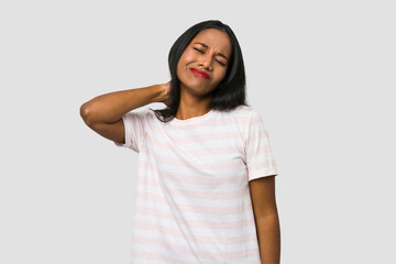 Young Indian woman cut out isolated on white background having a neck pain due to stress, massaging and touching it with hand.