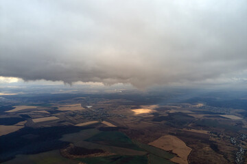 Aerial view from high altitude of earth covered with puffy rainy clouds forming before rainstorm