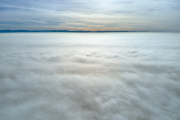 Aerial view from high altitude of earth covered with puffy rainy clouds forming before rainstorm