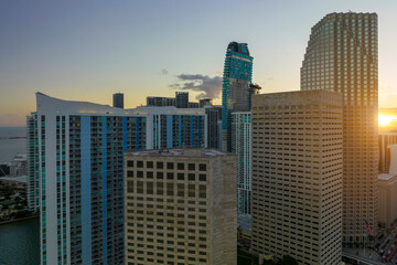 Obraz premium Aerial view of downtown office district of of Miami Brickell in Florida, USA at sunset. High commercial and residential skyscraper buildings in modern american megapolis