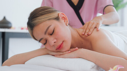 Fototapeta na wymiar Young woman having massage in the spa salon.