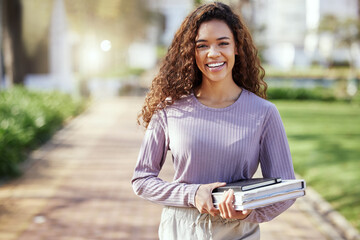 Woman with smile, books and education with student on campus, learning with scholarship at university and outdoor. Female person in portrait with smile, college course material and mockup space