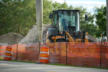 Protective restriction barrier at industrial construction site. Safety mesh fence for pedestrians