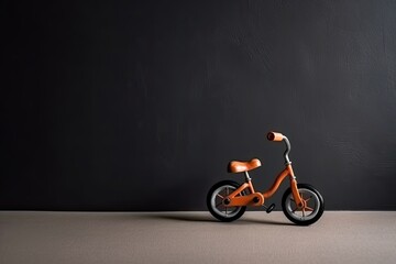 0281. Bicycle toy in front of dark wall. Generative AI