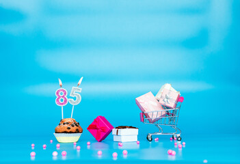 Creative card Happy birthday background for a girl or woman with a number of candles in a muffin...