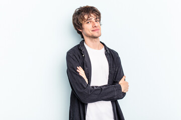 Young caucasian man isolated on blue background happy, smiling and cheerful.