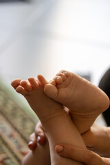 close-up of a baby holding their own toes