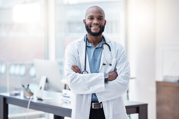 Doctor, portrait of a black man with his arms crossed and in his office at his workplace with a lens flare. Confident or proud, happy and male scientist or surgeon with arm folded in a laboratory