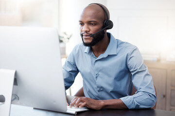 Black man, computer and call center, contact us and communication, concentrate with headset and...