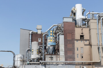 Factory in rural farmland. Multicolored machinery food processing plant.