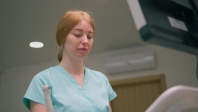 concentrated Gynecologist diagnoses the patient in the clinic with the help of a vaginal ultrasound device