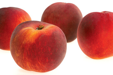 Red peaches on white background.
