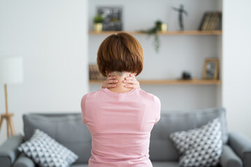 Neck pain, woman suffering from backache at home