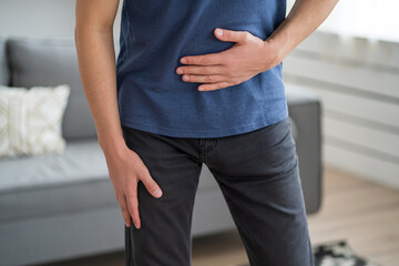 Stomach ache, man with abdominal pain suffering at home