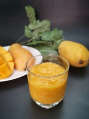 Mango smoothie on black background