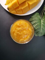 Mango smoothie on black background