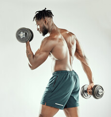 Fototapeta na wymiar Exercise, strong and black man with dumbbells, workout goal and healthy guy on a white studio background. Male person, model or bodybuilder with gym equipment, strength and power with muscle and body