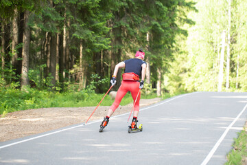 Roller skis.A woman runs in a summer park on roller skis.Cross country skilling.