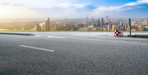 Asphalt pavement and urban building skyline
