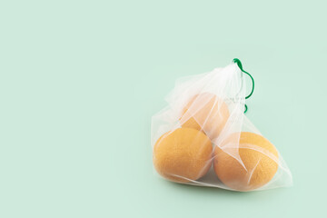 eco friendly fruit bag with oranges on a natural green background