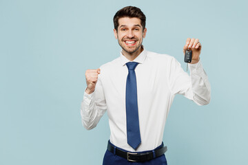 Young employee IT business man corporate lawyer wears classic formal shirt tie work in office hold in hand car keys fob keyless system isolated on plain pastel light blue background studio portrait.