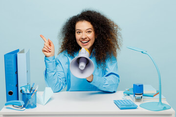 Young employee business woman in casual shirt sit work at white office desk scream in megaphone...