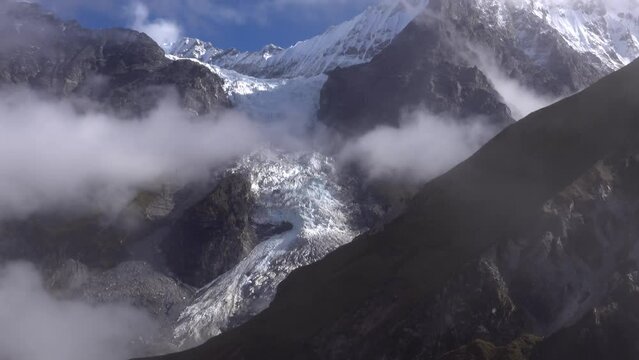 Glacier coming down in valley from mountain with clouds
Himalaya mountain Long shot from Nepal, 2023
