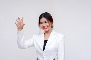 A playful young woman doing a cat claw gesture while looking at the camera. Isolated on a white...