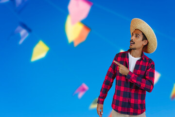 Black Man With Hat on Junina Party Outfit  Background.  Young man wearing traditional clothes for Brazilian June festival.