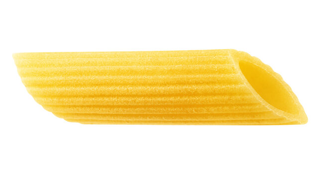 raw Penne Rigate, uncooked Italian Pasta, isolated on white background, full depth of field
