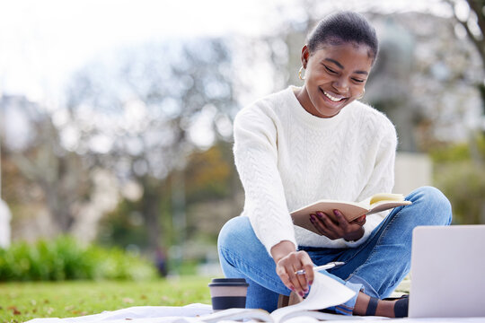 Woman, reading and laptop in the outdoor at college for an education in africa with books. Female student, university and tech with a notebook at the park for knowledge and research for phd.