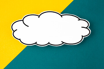 The White speech bubble shaped post it note on yellow and green background with copy space.