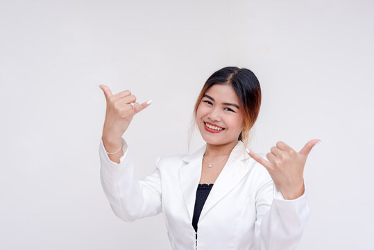 A laid back and smiling young woman making shaka sign with both hands. Isolated on a white background.