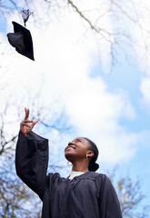 Success, graduation and a black woman throwing a hat for education achievement at a college. Happy,...