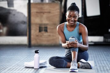 Smartphone, happy or black woman in gym on social media to relax on fitness or exercise or workout break. Athlete, meme or funny girl with mobile app for online digital communication after training