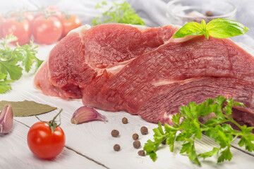 a large piece of fresh meat with herbs and spices