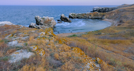 A small cozy sandy cove among the coastal rocks in the eastern Crimea, Kazantip, the Black Sea